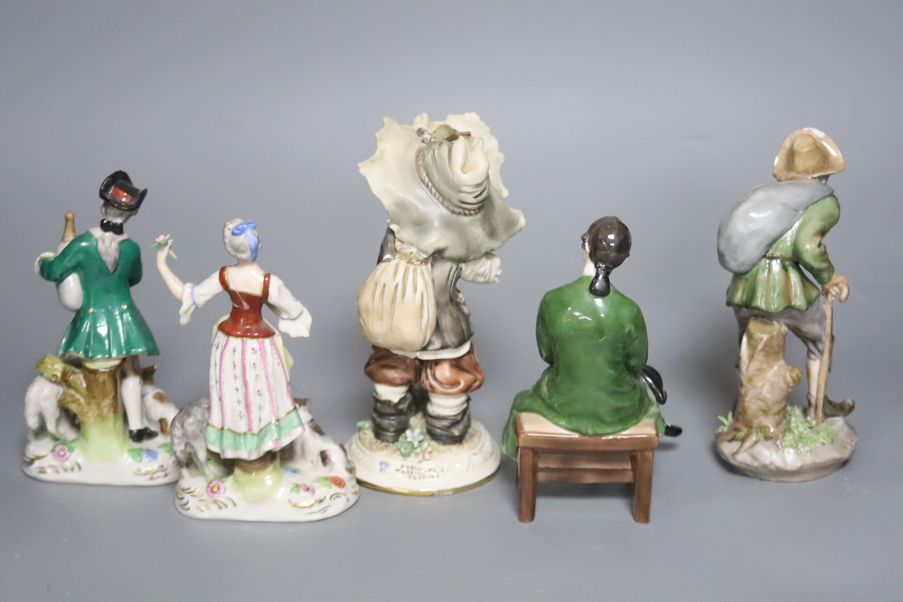 A Doulton figure 'A Gentleman from Williamburg', HN2227, four Continental porcelain figures and a pair of vases